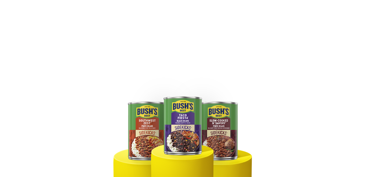 Three cans of Bush's Sidekicks beans on a yellow pedestals.