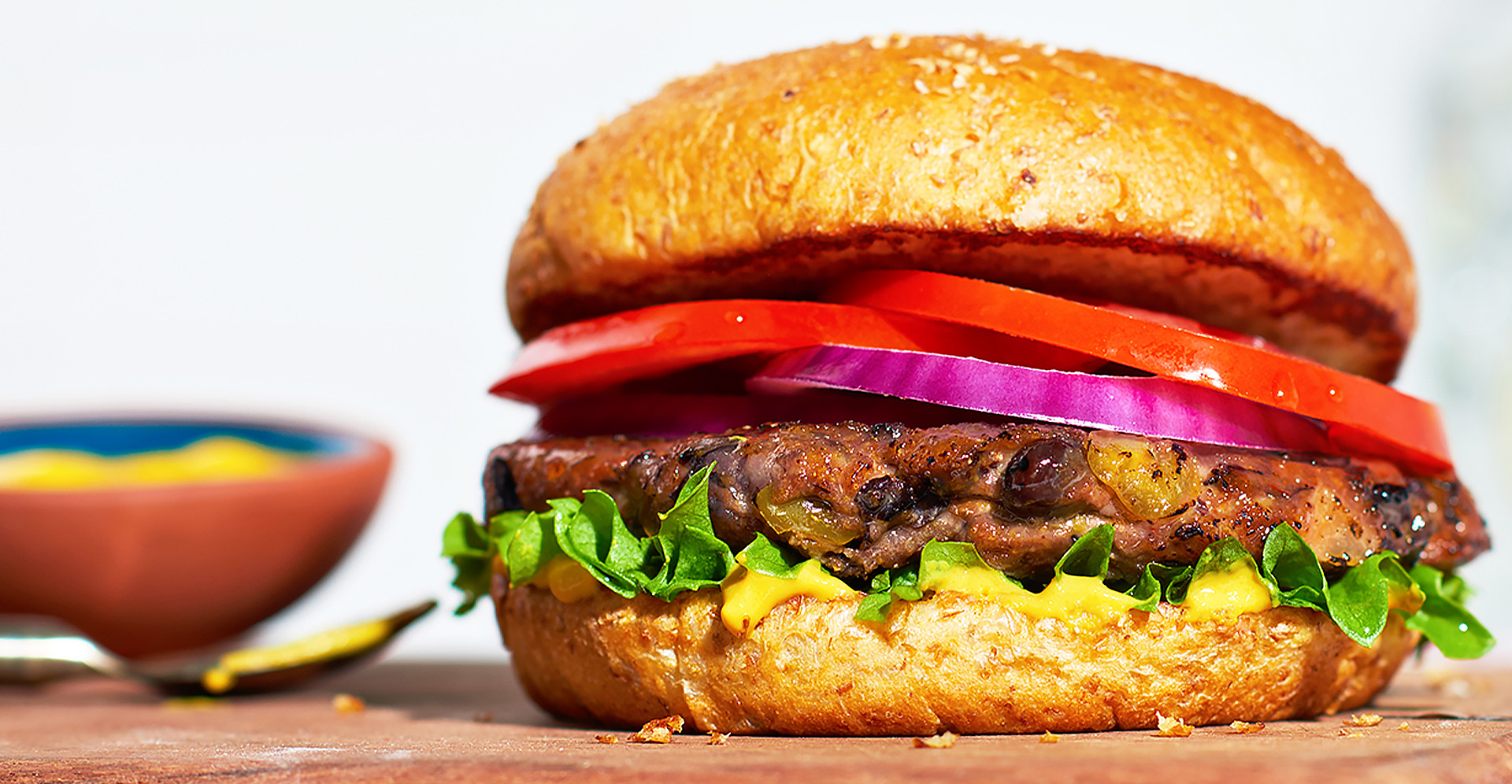Black bean burger on bun with lettuce, tomato and onion